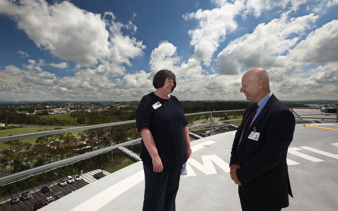 Tour: Project lead Liz Smith and Hunter New England Health chief Michael DiRienzo take in the view from the rooftop helipad at the new Maitland Hospital. Picture: Simone De Peak