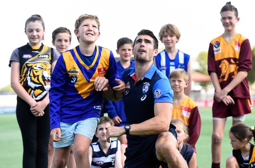 PACK LEADER: Western Bulldogs captain Easton Wood with Fraser Sutton and fellow Ballarat Football League juniors promote responsible gambling at Mars Stadium. Picture: Adam Trafford