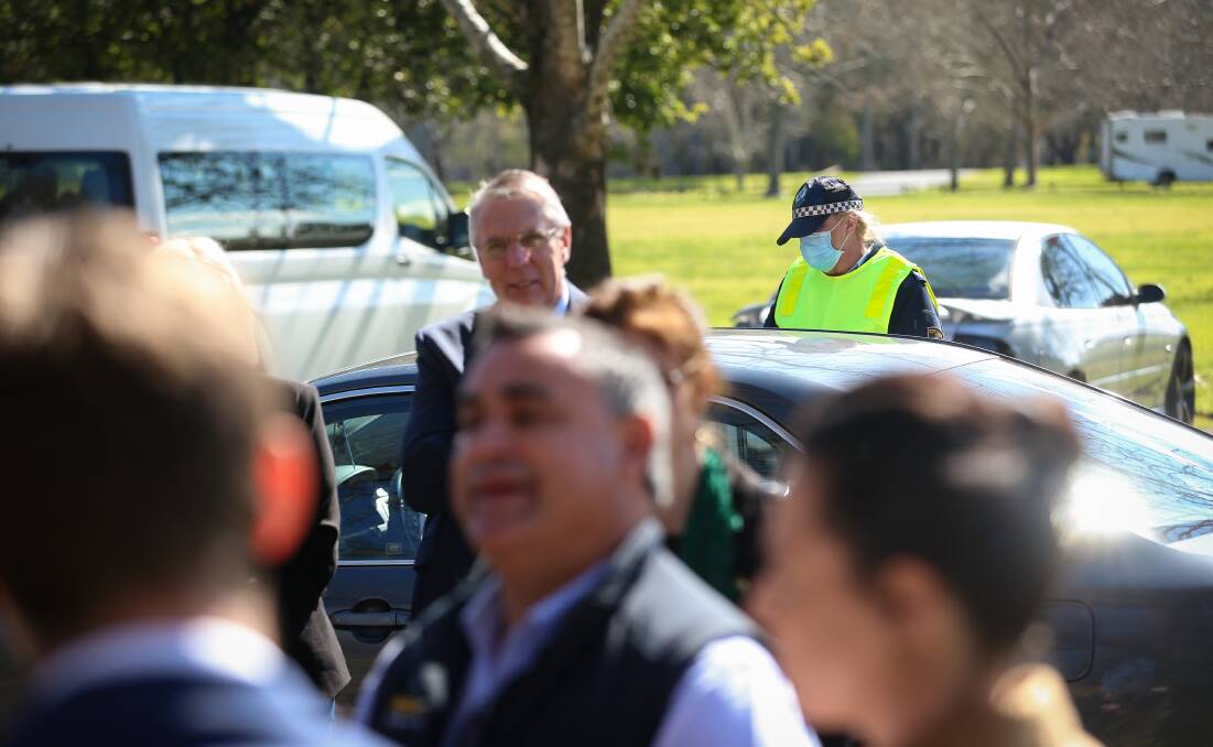 Checking goes on: A policewoman inspects a car as a media conference with Nationals leaders Peter Walsh and John Barilaro gets underway. Picture: JAMES WILTSHIRE