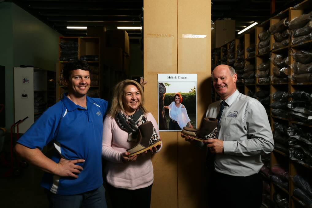 Helping others: Tony and Stephanie Mortel and Steve Duggan with the limited edition Melbo ugg. Picture: Jonathan Carroll
