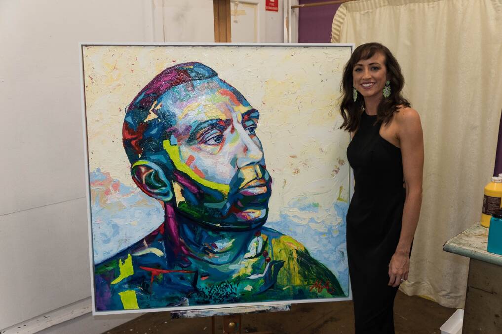 ENTRY: Artist Megan Adams with her multicoloured portrait of Adam Goodes, who was subject to ugly racism in the final year of his AFL career. Adams will enter the piece in this year's Archibald Prize.