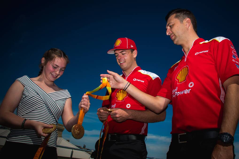 MEDALS: Supercars drivers Scott McLaughlin and Fabian Coulthard with Maddi Elliott (left) in Newcastle on Tuesday. Picture: Simon McCarthy