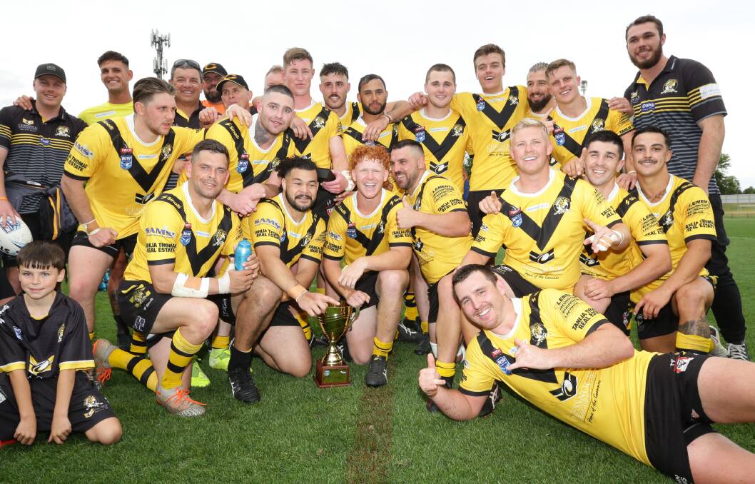 PLANS: Cessnock's Robert Tuliatu (front row, second from left with hand on trophy) after last year's Newcastle Rugby League grand final. Picture: Jonathan Carroll