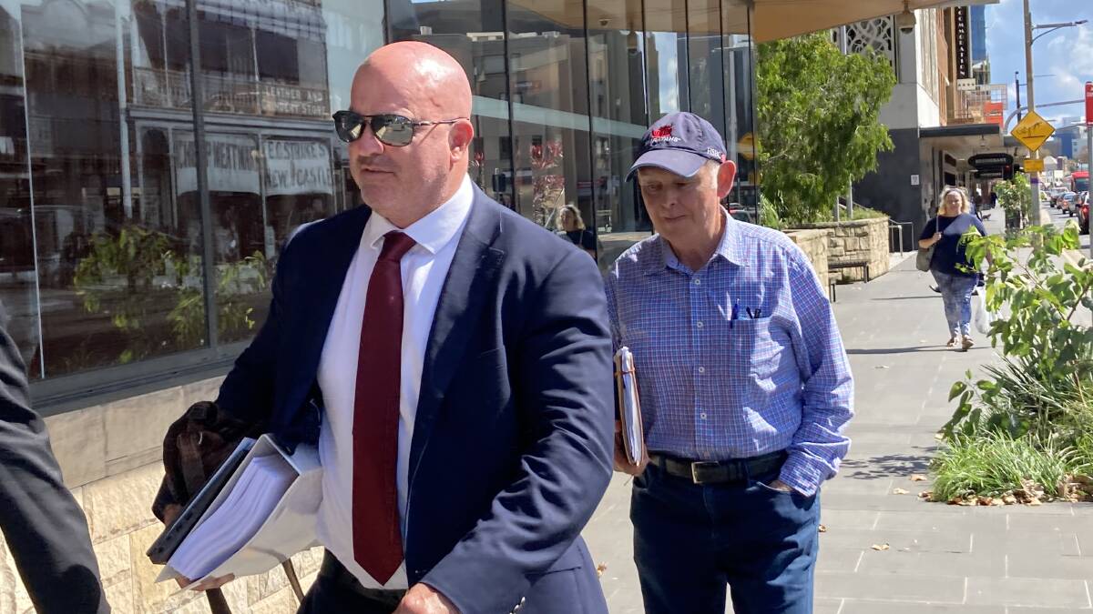 Maitland accountant Michael Unicomb, right, with his solicitor Mark Ramsland outside Newcastle District Court on Monday after pleading guilty to obtaining financial advantage by deception last year.