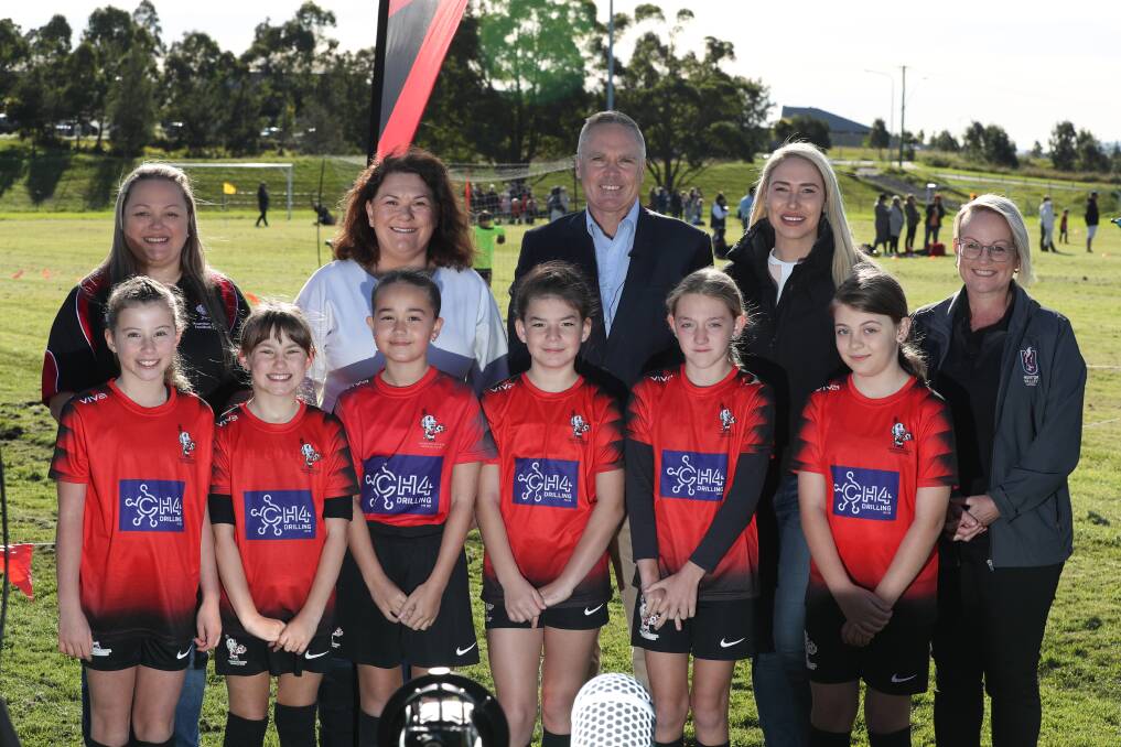 GROWING THE GAME: Northern NSW Football chief executive David Eland, pictured with Member for Paterson Meryl Swanson on his left and Paterson Liberal candidate Brooke Vitnell on his right at Thornton Junior Football Club on Saturday. Picture: Sproule Sports Focus