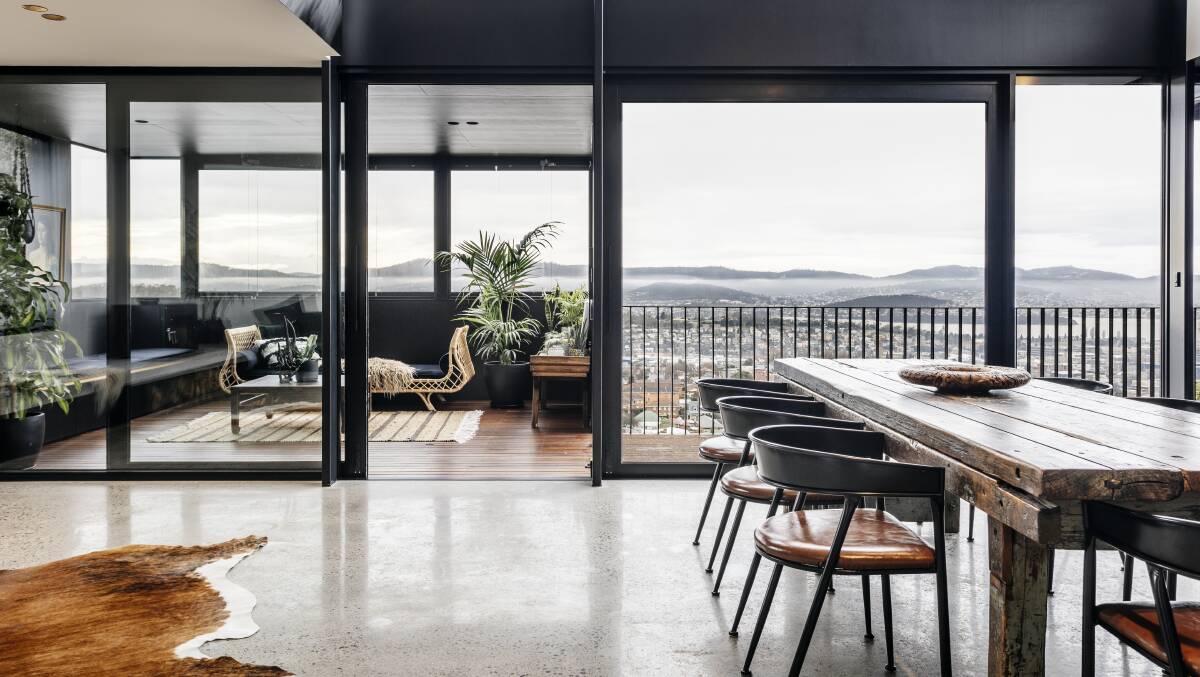 Reinventing a 1980s red brick veneer house into a modern warehouse-inspired family home that commands views over West Hobart. Pictures: Adam Gibson. 