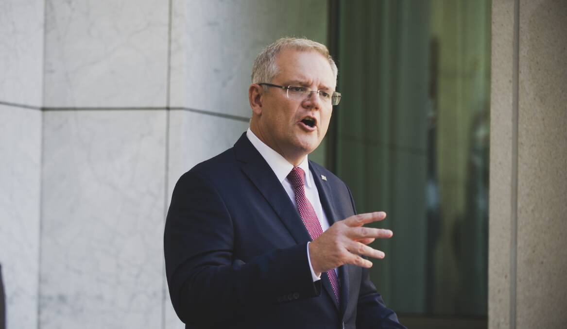 Prime Minister Scott Morrison in Canberra on Tuesday, announcing a new rule limiting the number of people allowed at inside venues together. Picture: Dion Georgopoulos