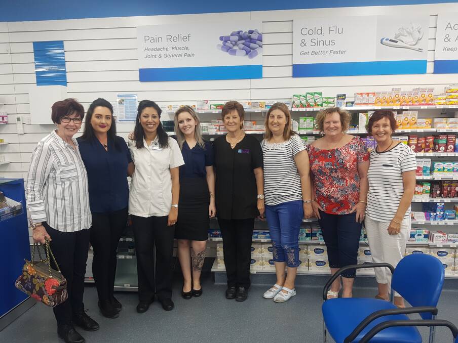 Care:Caroline Enright (third from the left) with the Telarah Pharmacy team with some of their loyal customers from within the community.