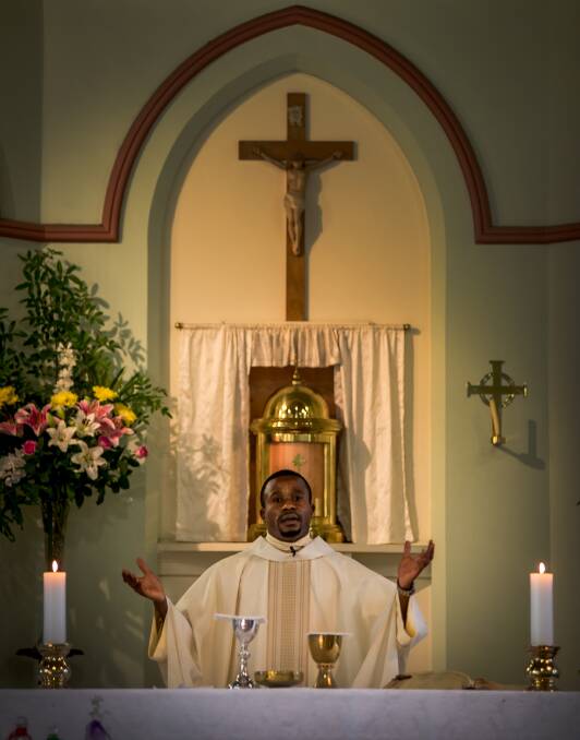 FAITH: Father Camillus Nwahia addresses the congregation at St Patrick's Lochinvar on Easter Sunday. Picture: Perry Duffin