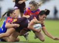 TOUGH DAY: Knights players take down Brisbane forward Kaitlyn Phillips at WIN Stadium. Picture: Getty Images 