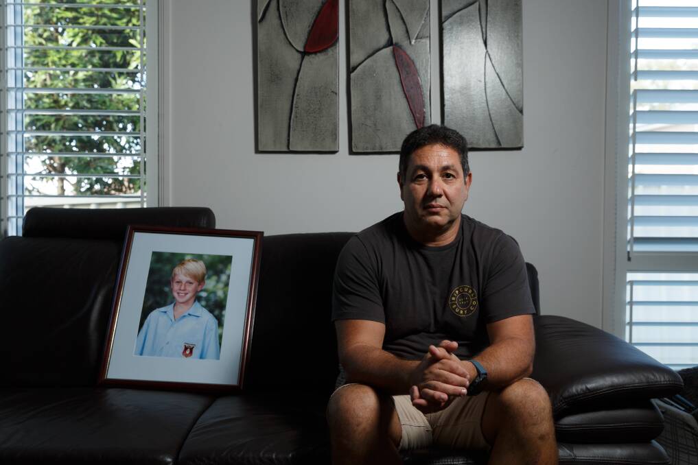 TRAGIC LOSS: Joe Caruso at home on Friday with a photo of his son Josh, who died in 2013. Picture: Max Mason-Hubers 
