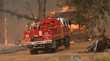 Firefighters battle the blaze as it consumes a shed near Buangor on February 22. Picture by Lachlan Bence