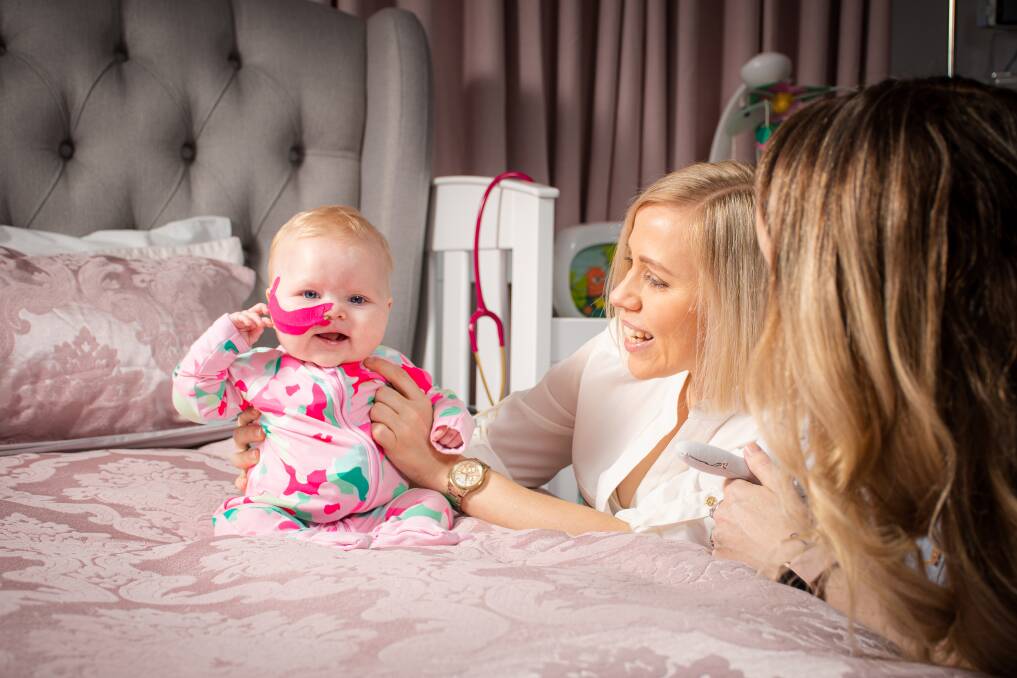 IN LOVE: Tresne and Carly Middleton at home in Broadmeadow with baby Poppy Grace. Picture: Simon McCarthy