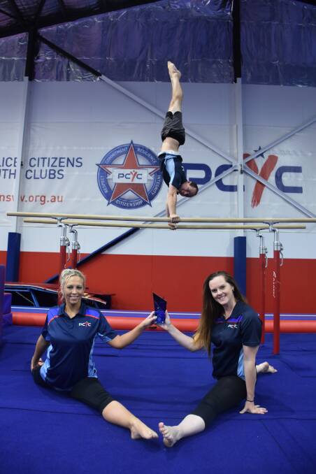 HANDSTAND-ING OVATION: Maitland PCYC gymnastics program leader Ryan Phillips (centre) with coaches Kareena Adams and Christieleigh Armstrong.