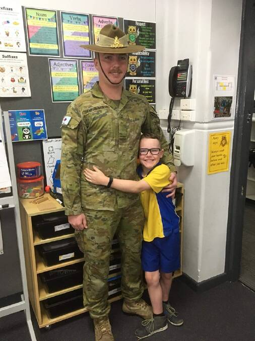 BROTHERS IN ARMS: Aidan Smoothy, 22, surprised his brother Connor at Maitland Public School. Picture: Maitland Public School