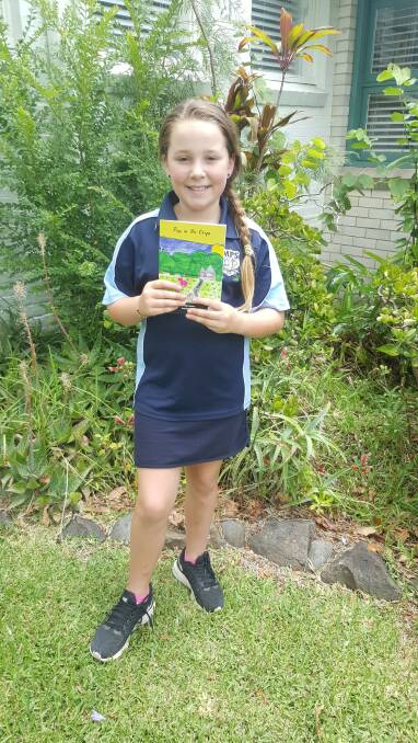 BIG ACHIEVEMENT: Morpeth Public School's Maggie Carpenter with her published book Pigs in the Crops.