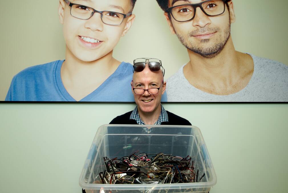 Specsavers manager Robert Allen with donated glasses. Picture: Jonathan Carroll