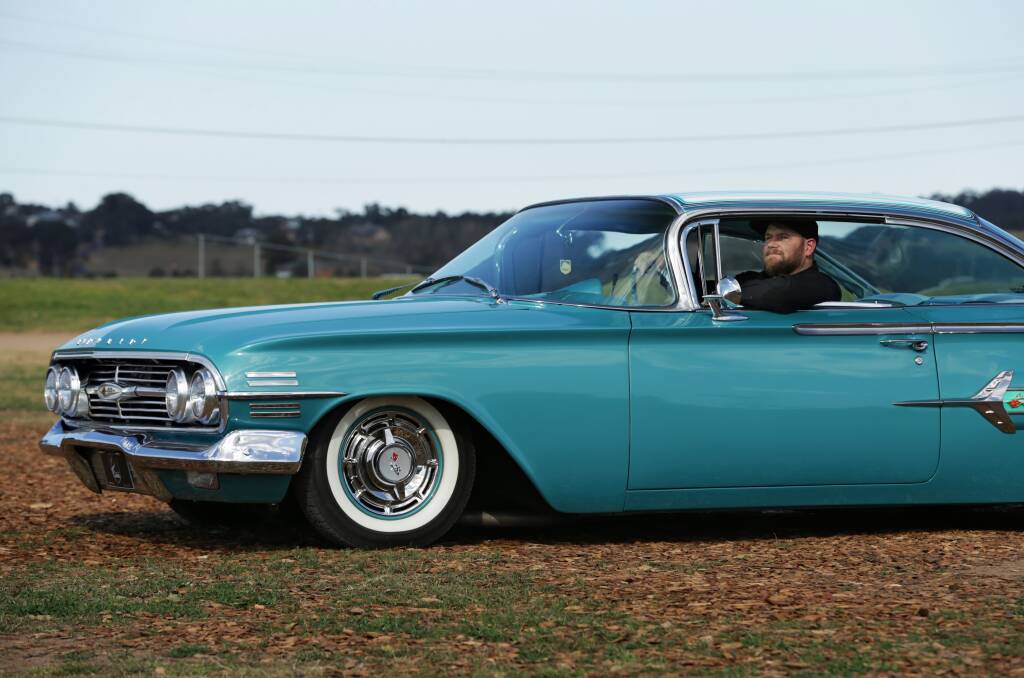 LOOKING GOOD: Brad Lowe with a 1960 Chevrolet Impala Coupe, one of the cars on show from MC Customs. Picture: Simone De Peak