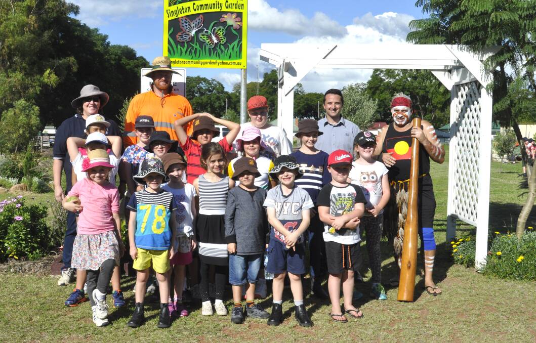 Singleton Council’s Melinda Hale, Kevin Lomax from Singleton Community Garden, Keith Simkin from Glencore and Uncle Perry from Kotara School with children from Singleton Out of School Hours Care (OOSHC) at the event.  