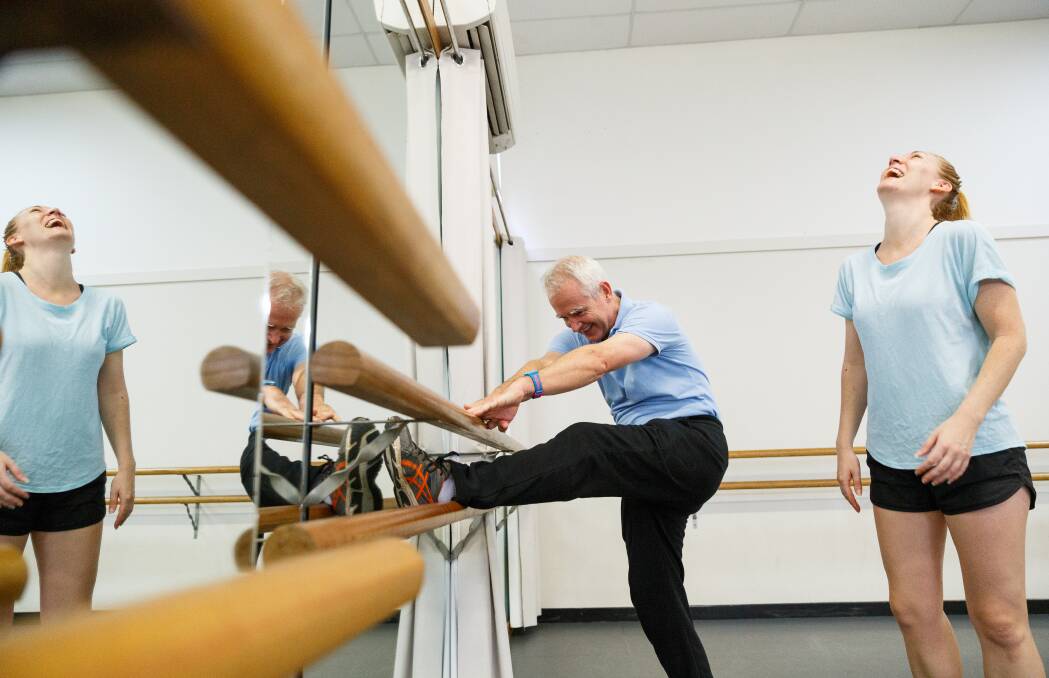 Scott Bevan stretches - sort of - as dance teacher Rachel Mackie looks on. Picture: Max Mason-Hubers