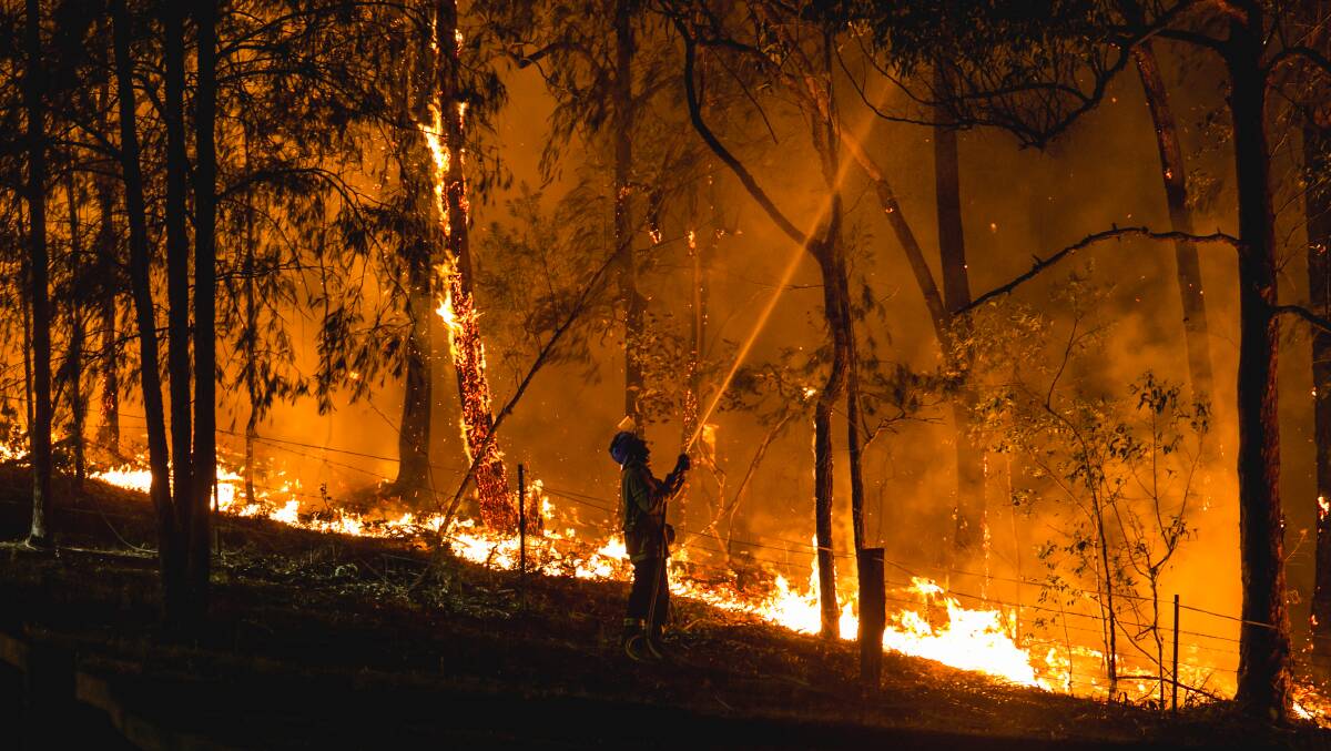 BATTLE: An RFS member fighting the Martinsville blaze in October. Picture: Marina Neil