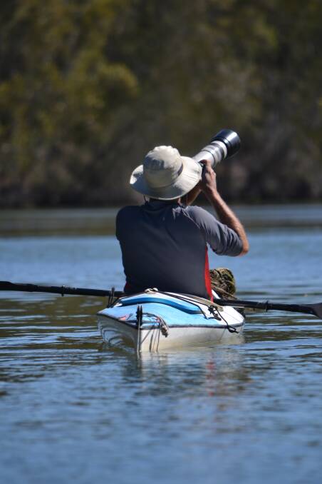 LENS MAN: Nick Raschke trains his camera on a bird from his kayak. Picture: Scott Bevan