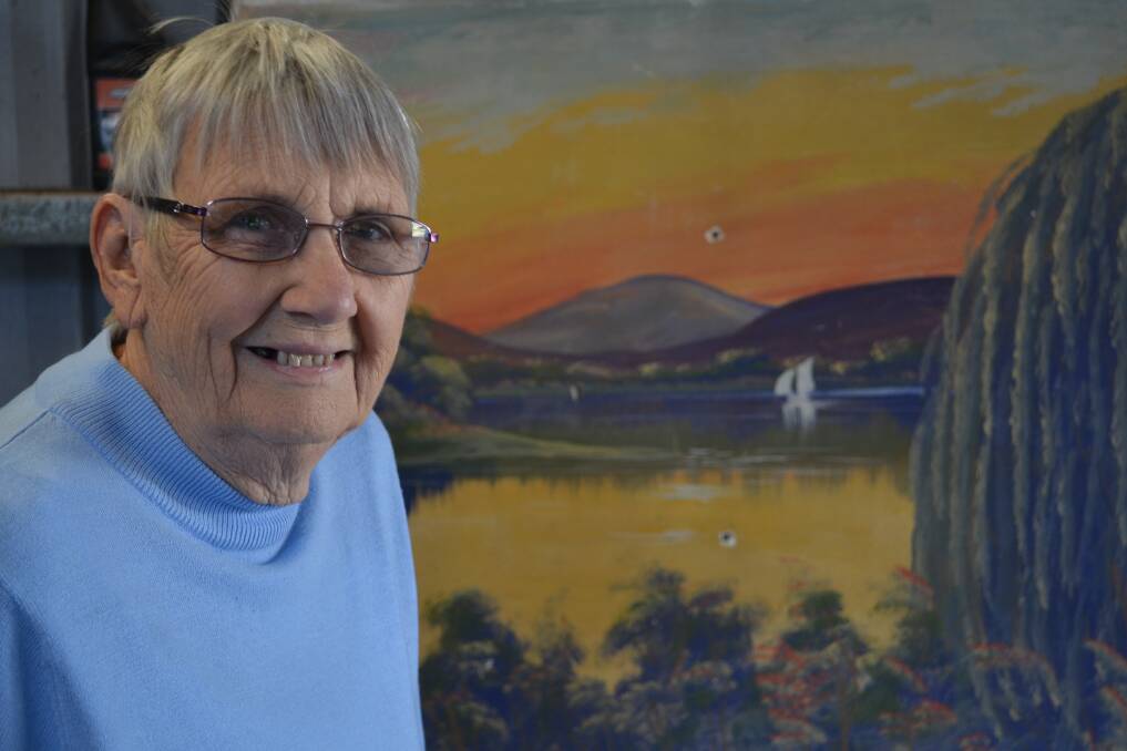 Deidre Geary with an Ernie Dickson painting rescued from a house about to be demolished in Swansea. Picture: Scott Bevan