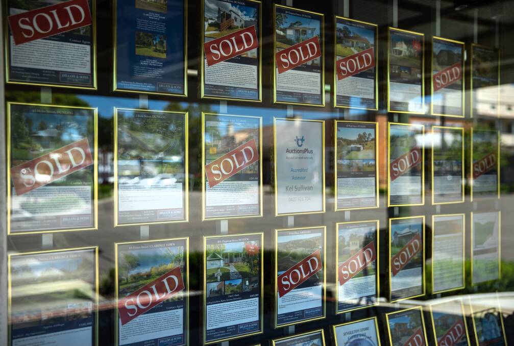 "Sold" stickers in a display window at Dillon & Sons real estate agency. Picture: Marina Neil
