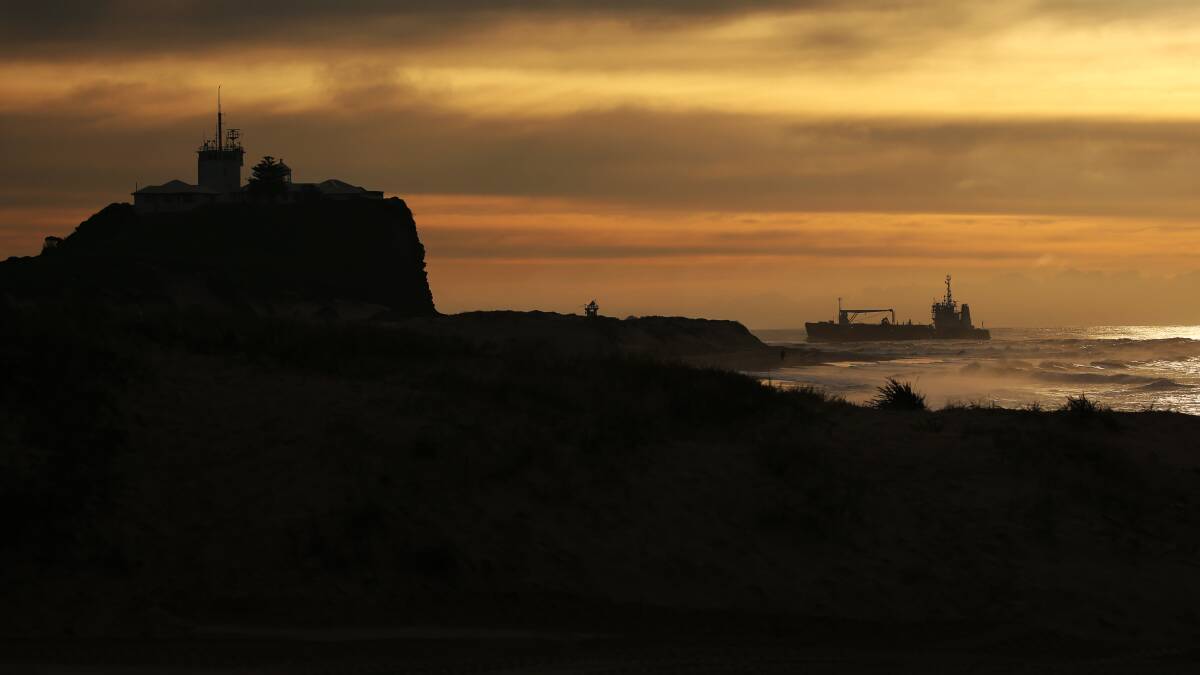 MORNING VOYAGE: The 'David Allan', Port of Newcastle's dredging ship, approaches Nobbys at dawn. Picture: Simone De Peak