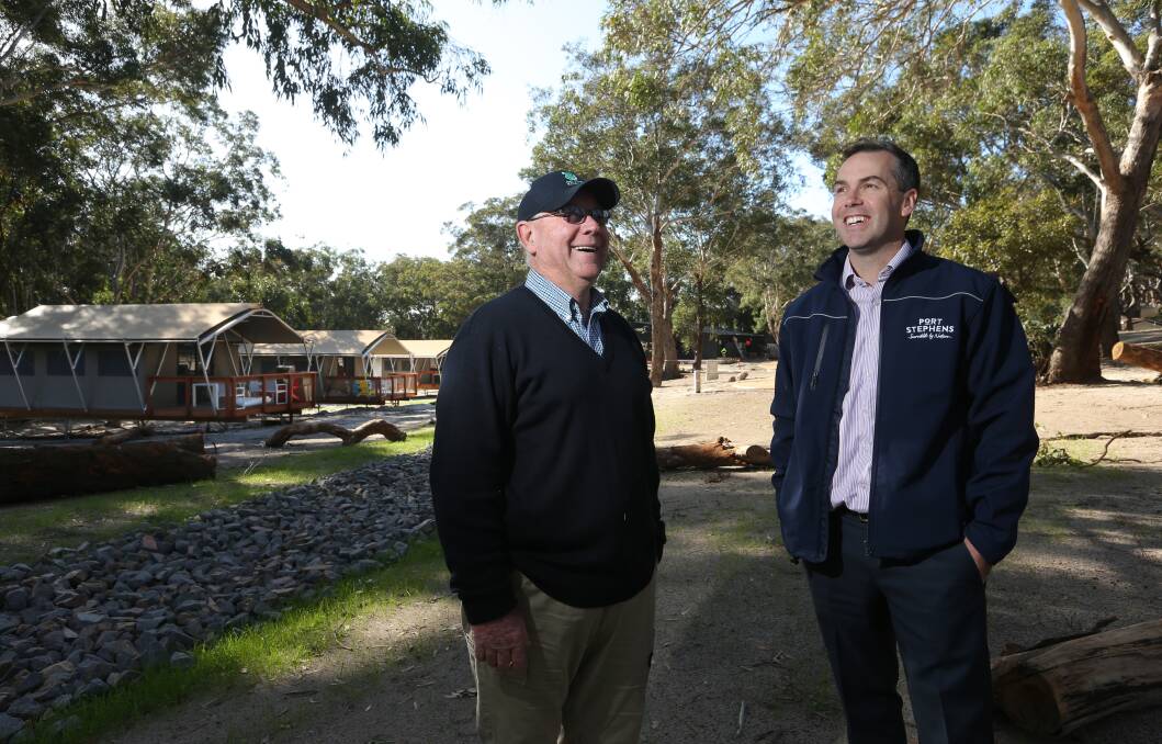 UNITED: Ron Land, from Port Stephens Koalas, and the mayor, Cr Ryan Palmer, at the sanctuary, with the new "glamping" facilities in the background. Picture: Simone De Peak