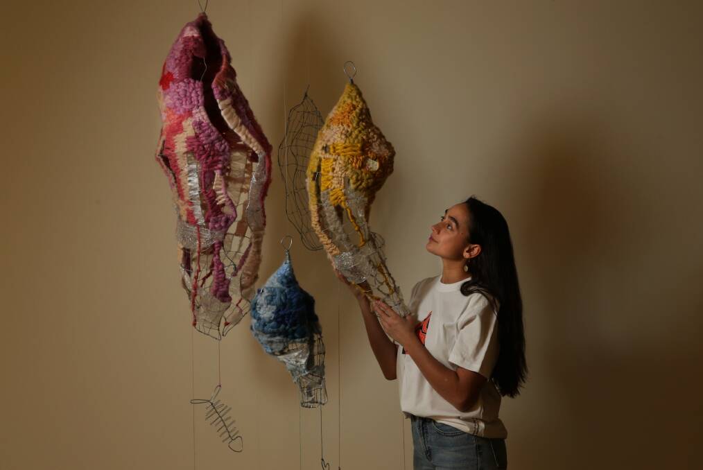 Artist Jasmine Miikika Craciun with her work, "Empty Water Vessels". Picture: Simone De Peak