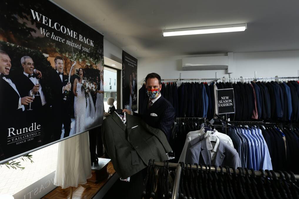 SUITING THE TIMES: Andrew Rundle, from Rundle Tailoring, prepares to reopen his Hunter Street store to customers on Monday. 