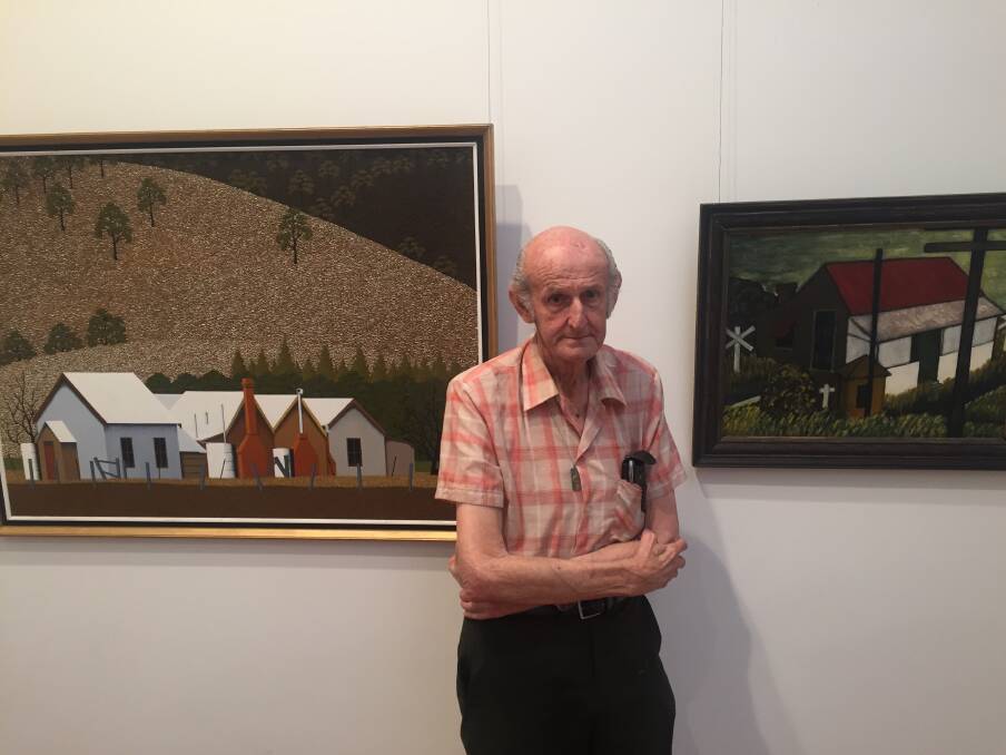 LONG CAREER: Max Watters stands before a painting of Murrurundi farm buildings (left) and one of his earliest works, the 1962 image, "House at No.5", at the exhibition. Picture: Scott Bevan 