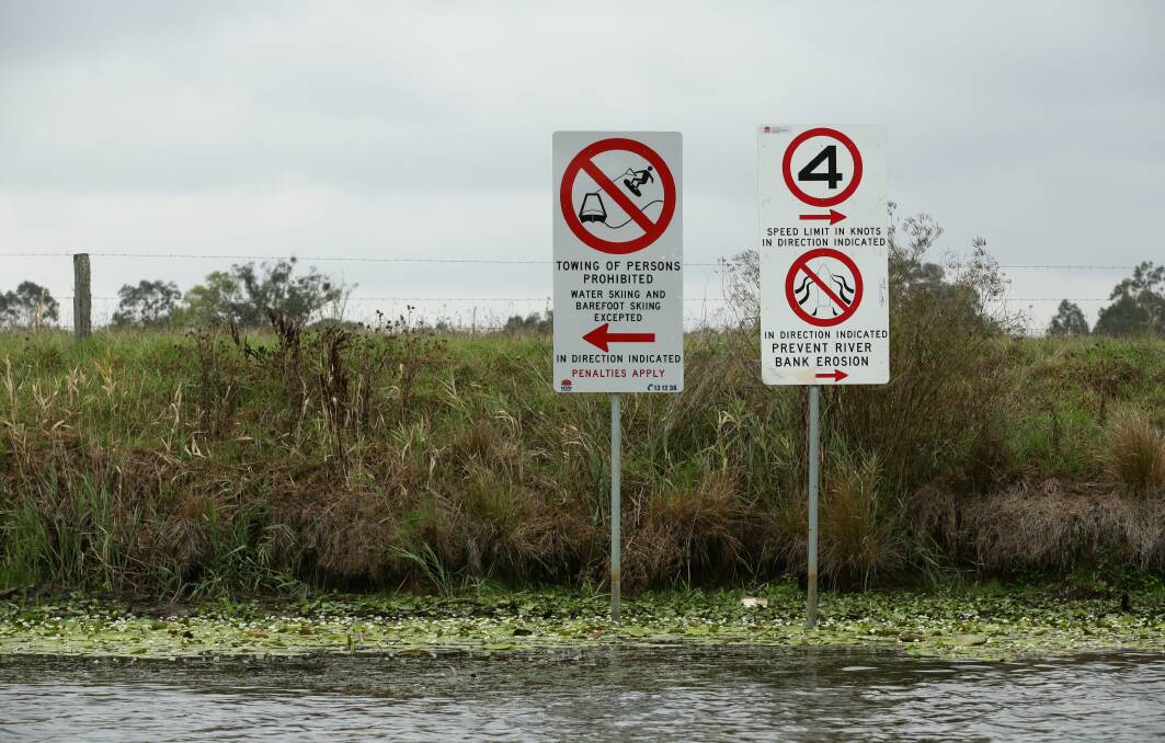CROSS CURRENTS: Boating signs along the Seaham Weir Pool on the Williams River. Picture: Simone De Peak 
