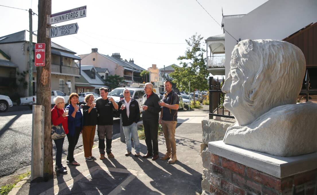 HONOUR: Friends gather to toast the new sculpture of former gallery owner Anne von Bertouch in Laman Street. Picture: Marina Neil 