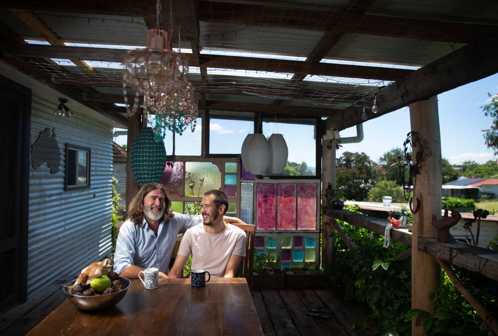 Matt Wakeham and Marty Wong on the back deck of their new home in Dungog. Picture: Marina Neil