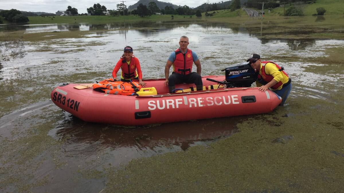 LIFELINE: The Stockton SLSC crew prepare to ferry Hillsborough resident Malcolm Smith and the supplies he had bought. Picture: Scott Bevan