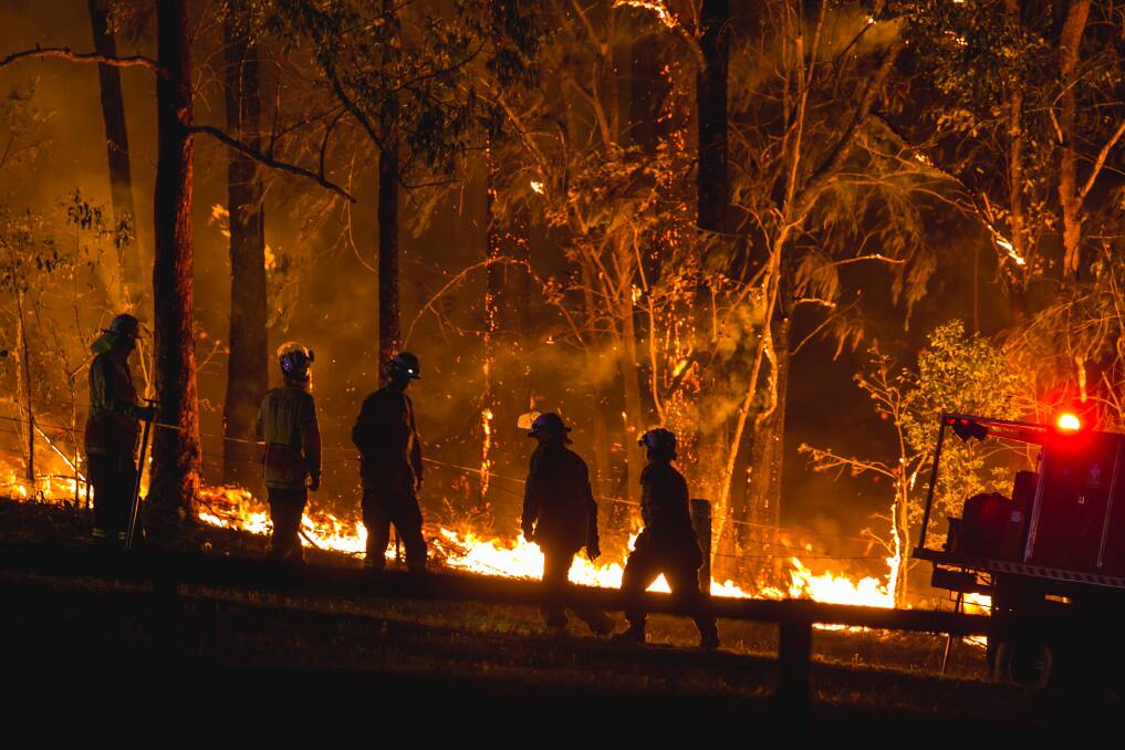 Firefighters confront the flames near the village of Martinsville in October, 2019. Picture: Marina Neil 