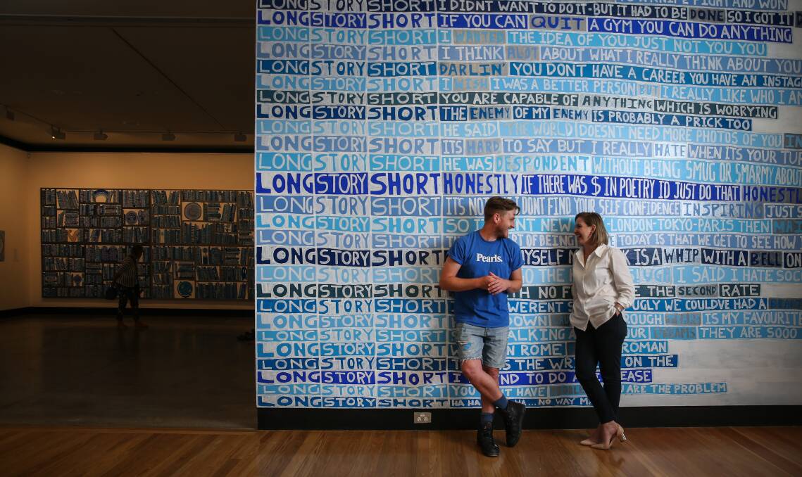 BLUE HUMOUR: Artist Lucas Grogan and gallery coordinator Kattie Bugeja at the "Long Story Short" exhibition. Picture: Marina Neil