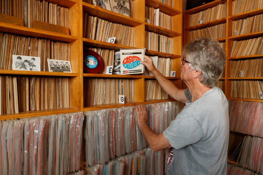 Rick Pointon looks at items in his vast record collection. Picture: Max Mason-Hubers
