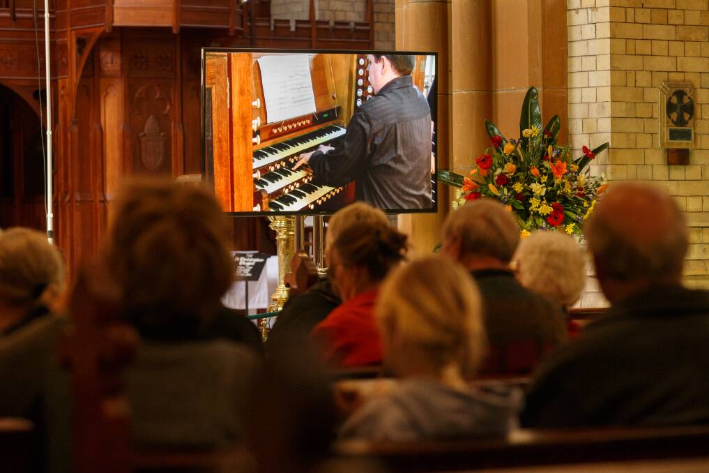 MELODIC: Organist Peter Guy is projected onto a screen for the audience as he performs in Christ Church Cathedral. Picture: Max Mason-Hubers 