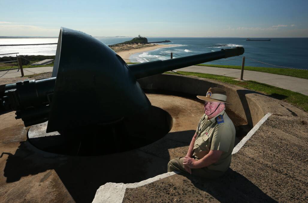Frank Carter, President of the Fort Scractchley Historical Society, in 2017 with one of the guns that fired on a Japanese submarine during WW2. Picture: Simone De Peak