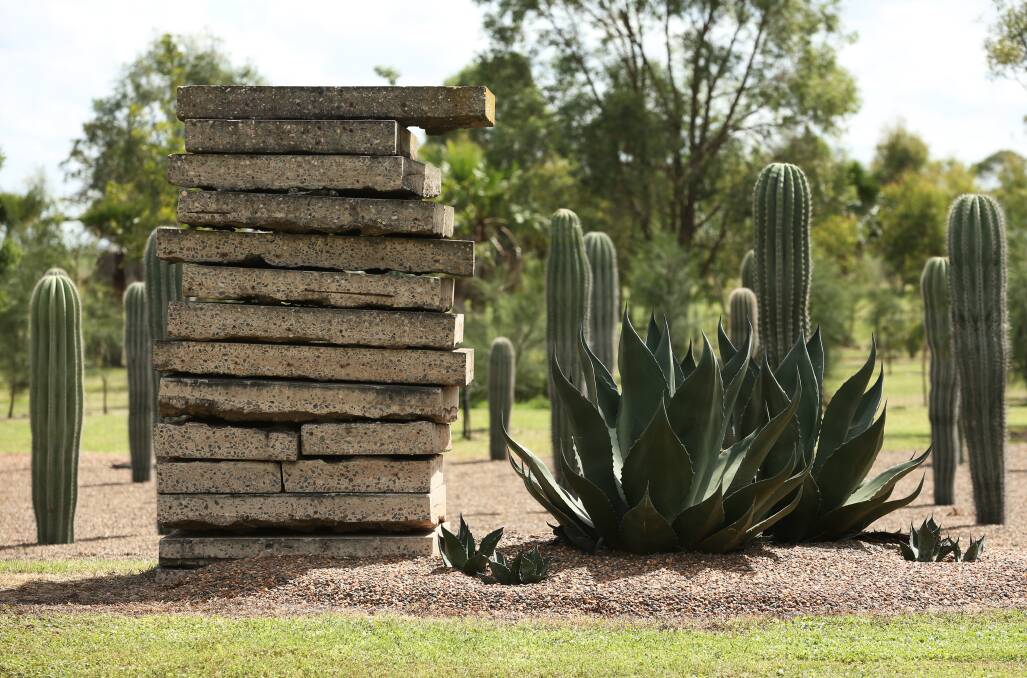 Cacti and a sentinel created from recycled slabs in the Dale Frank Botanical Gardens. Picture: Simone De Peak 
