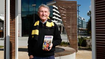 MAN OF WORDS: Retired sports broadcaster and Francophile Gerry Collins holding his new book and wearing the scarf of the French rugby side he supported. Picture: Max Mason-Hubers 