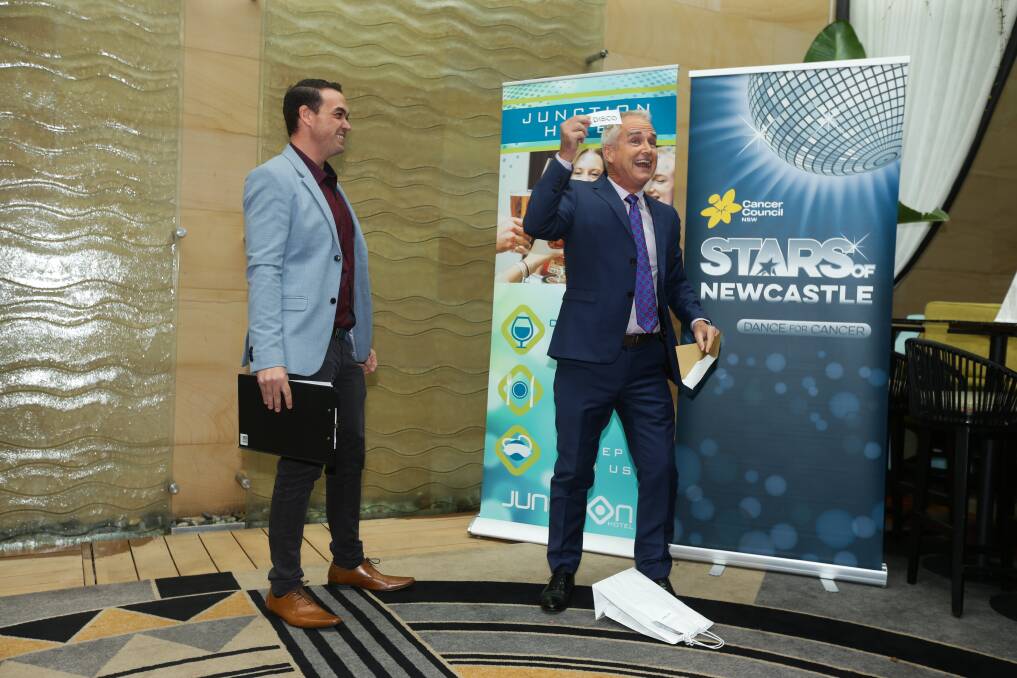 DISCO DELIGHT: Herald reporter Scott Bevan discovers what dance style he will be performing, as launch MC Anthony Burke watches on. Picture: Jonathan Carroll 