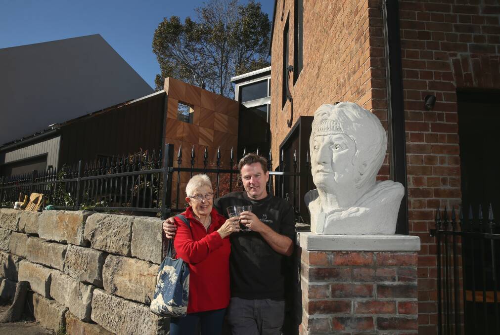 Former gallery manager Gael Davies and sculptor Graham Wilson toast the bust of Anne von Bertouch. Picture: Marina Neil 