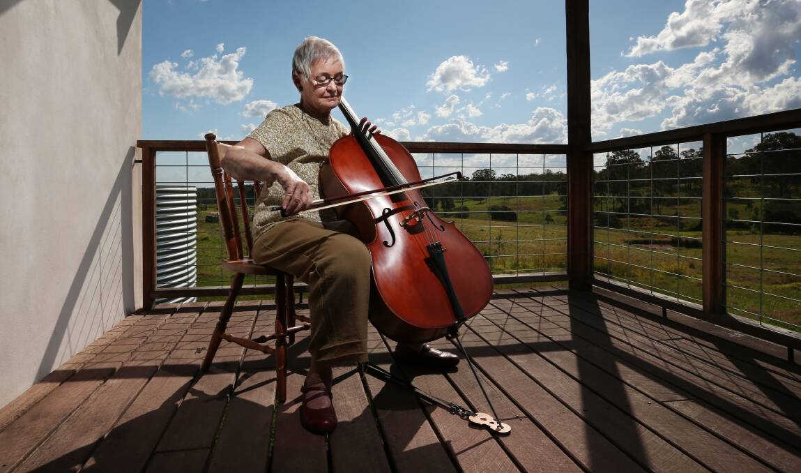 HARMONY: Resident Jane Purkiss playing the cello on her veranda.