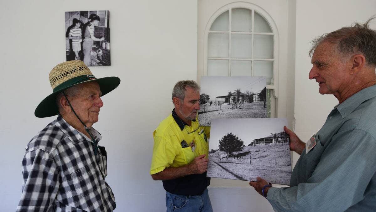 Glenrock Thursday Group members Bruce Clayton, John Knorr and John Le Messurier looking at a photo of how the Scout camp used to be. Picture: Jonathan Carroll