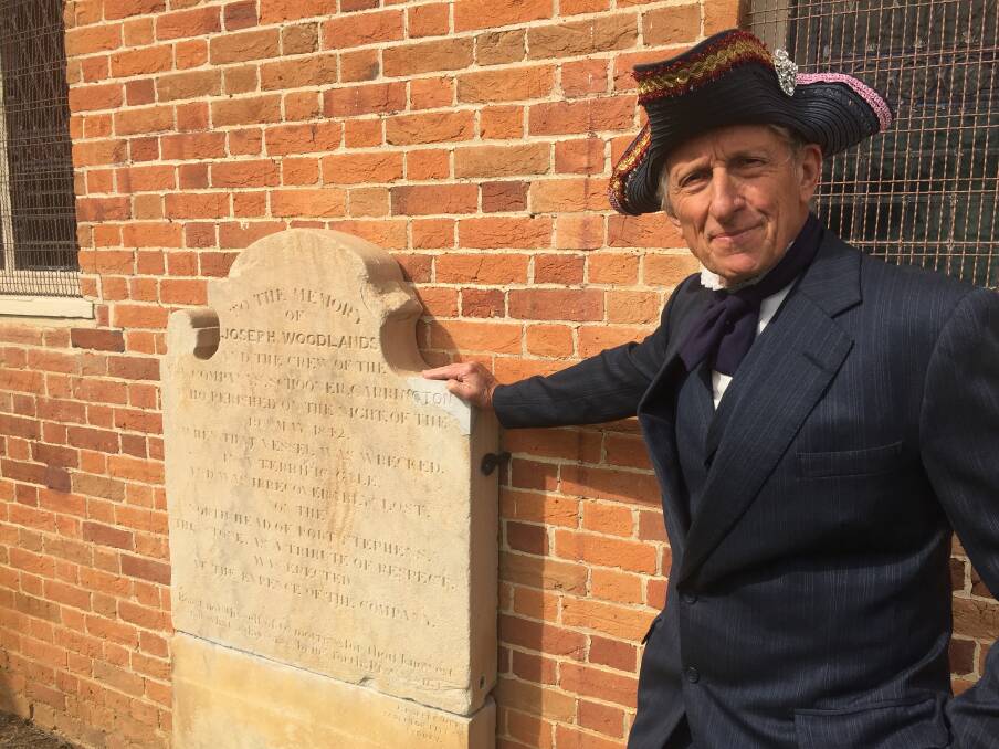 Jonathan King, dressed in a colonial costume, with the memorial stone outside the church in 2019. Picture: Scott Bevan