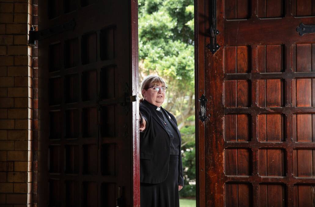The Anglican Dean of Newcastle, the Very Reverend Katherine Bowyer, shuts the doors of Christ Church Cathedral. Picture: Marina Neil